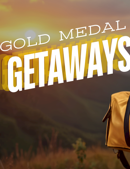 A person with a yellow duffel bag and a gold medal, set against a sunset backdrop, with bold &ldquo;GOLD MEDAL GETAWAYS&rdquo; text ending in period.